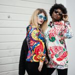 Two Women Standing Near Roller Shutter