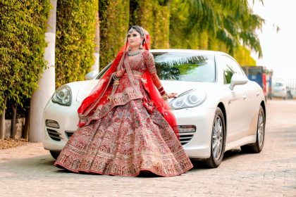 Indian Bride in a Lehenga Standing in front of a Car