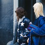 man and woman standing in front of building wearing jackets