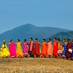 Group of People in Standing on Brown Grass Field