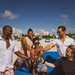 group of people standing on beach during daytime