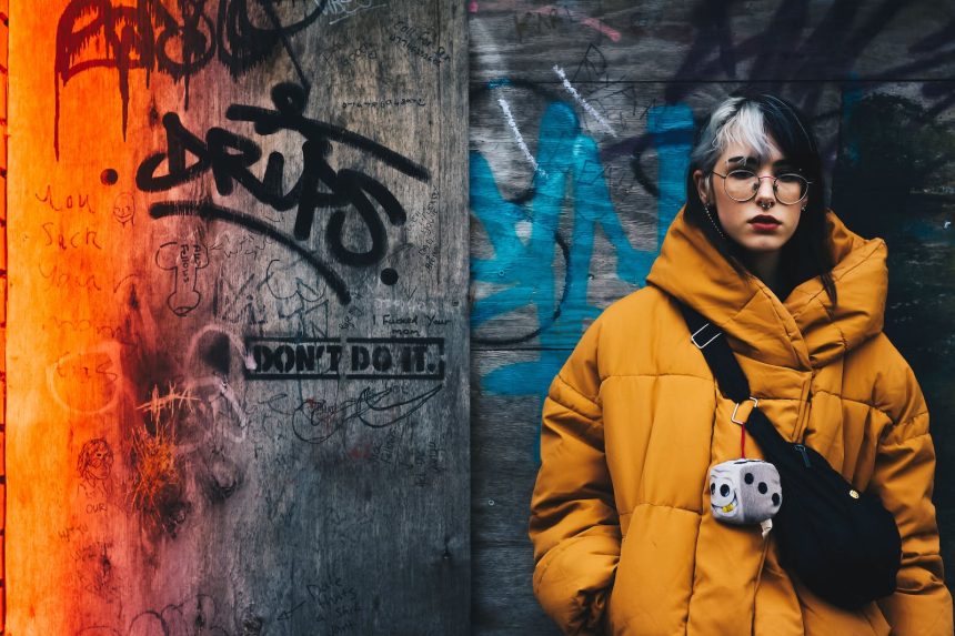 Woman in Yellow Coat With Black Crossbody Bag Closing Her Eyes