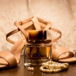 Brown Glass Fragrance Bottle Beside White Pearl Bracelets