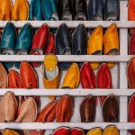 assorted-color shoe lot on white wooden shelf